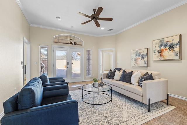 living room with crown molding, light carpet, ceiling fan, and french doors