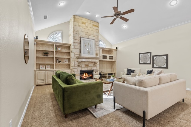 carpeted living room with a stone fireplace, high vaulted ceiling, and ceiling fan