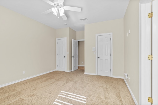 unfurnished bedroom featuring light colored carpet and ceiling fan