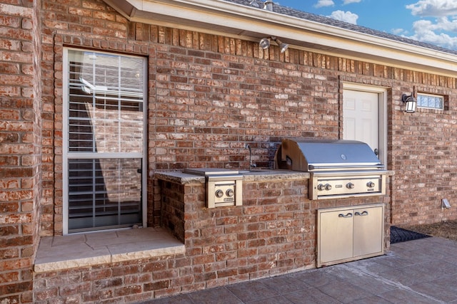 view of patio with exterior kitchen, a grill, and sink