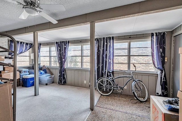 bedroom featuring a textured ceiling and light colored carpet