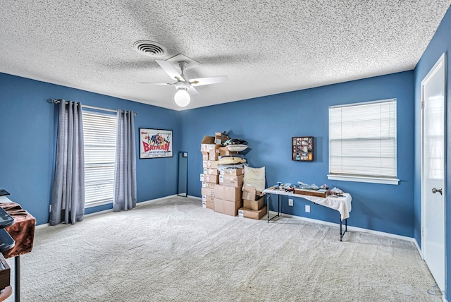 misc room featuring a healthy amount of sunlight, carpet, baseboards, and a ceiling fan