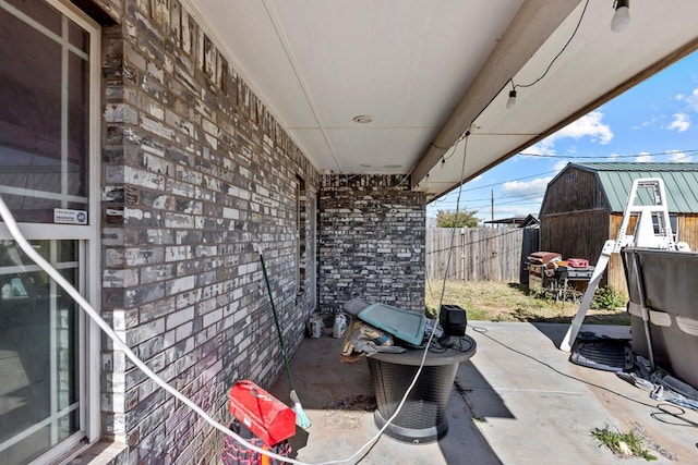 view of patio featuring an outbuilding