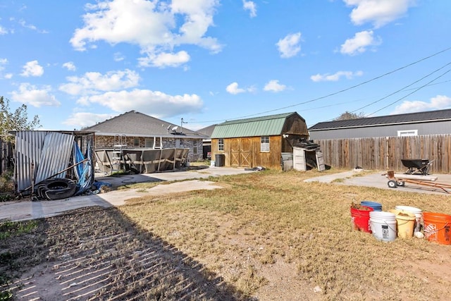 view of yard with a storage shed and central air condition unit