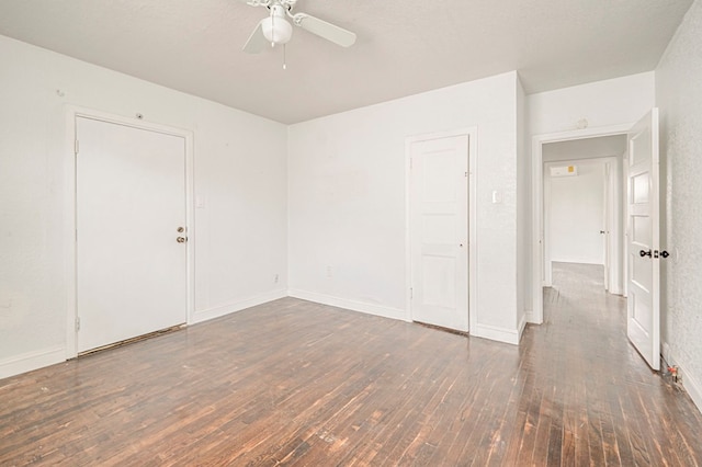 unfurnished room featuring ceiling fan and dark wood-type flooring