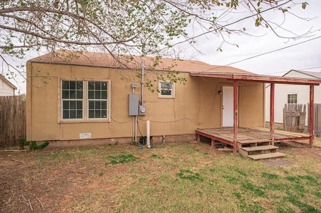 back of house with a wooden deck