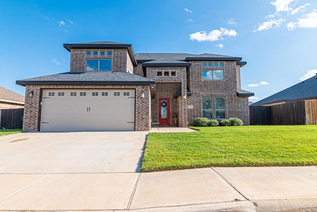 view of front of house with a garage and a front yard