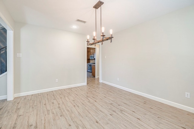 1221 Porterfield Rd, Midland, TX 79705 - empty room featuring a chandelier, light wood finished floors, baseboards, and recessed lighting