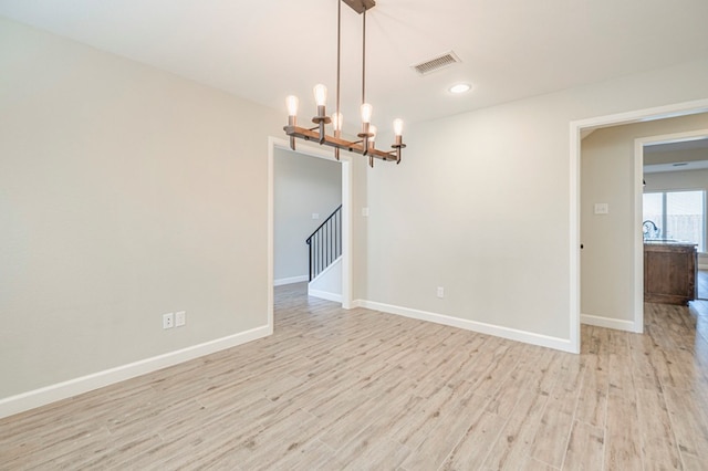 1221 Porterfield Rd, Midland, TX 79705 - unfurnished room with a chandelier, light wood finished floors, baseboards, and recessed lighting
