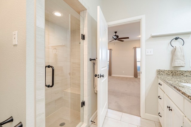 1221 Porterfield Rd, Midland, TX 79705 - bathroom featuring a shower stall, ceiling fan, vanity, and baseboards