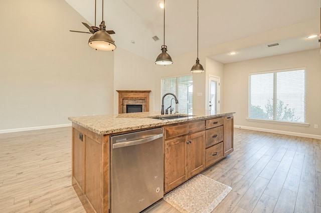 1221 Porterfield Rd, Midland, TX 79705 - kitchen featuring stainless steel dishwasher, a sink, light wood-style floors, baseboards, and high vaulted ceiling