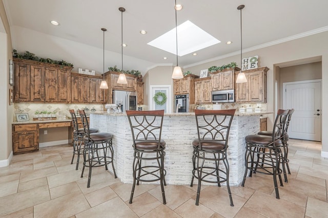 kitchen featuring stainless steel appliances, tasteful backsplash, a spacious island, decorative light fixtures, and light stone counters