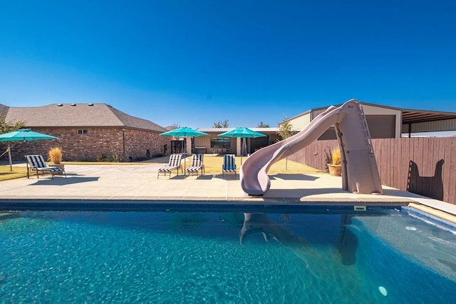 view of swimming pool featuring a patio and a water slide