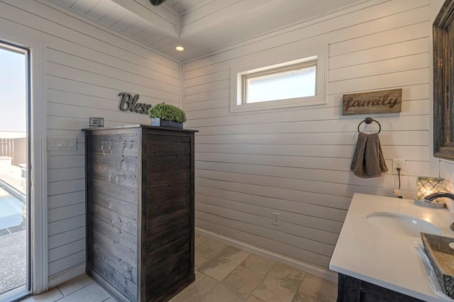 bathroom with a wealth of natural light and wooden walls