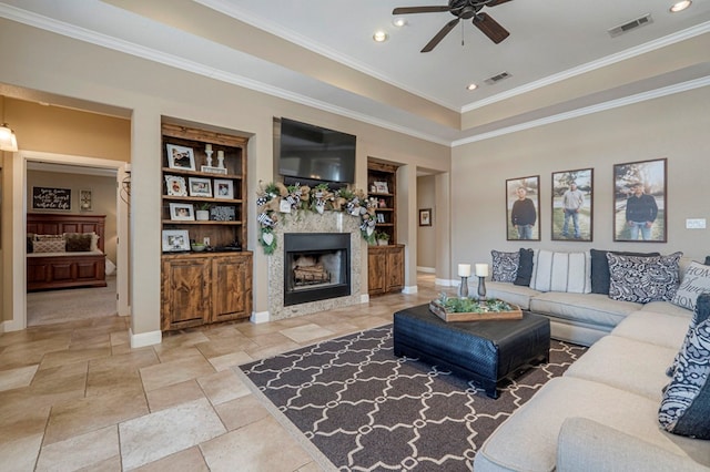 living room featuring ceiling fan, built in shelves, and ornamental molding