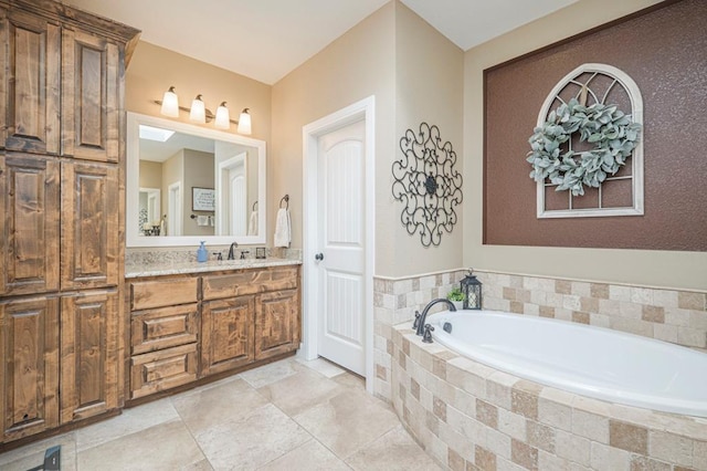 bathroom with tiled tub and vanity