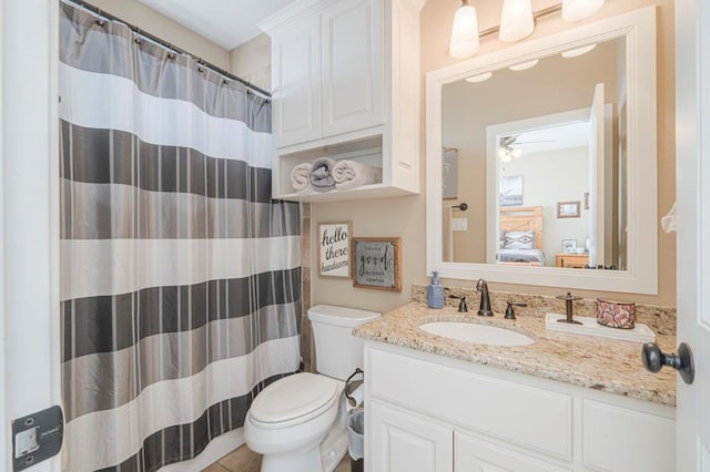 bathroom with toilet, vanity, walk in shower, and tile patterned flooring