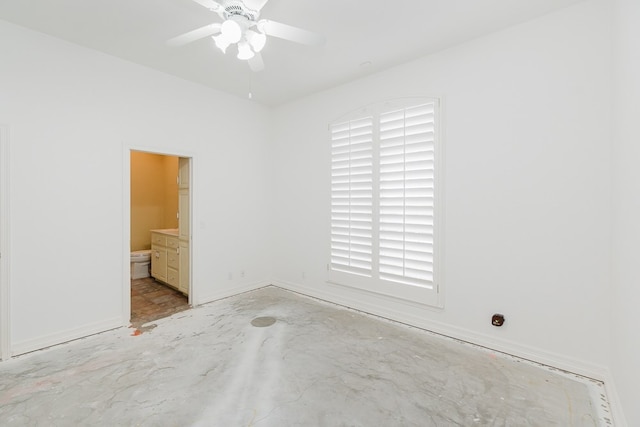 spare room featuring ceiling fan and plenty of natural light