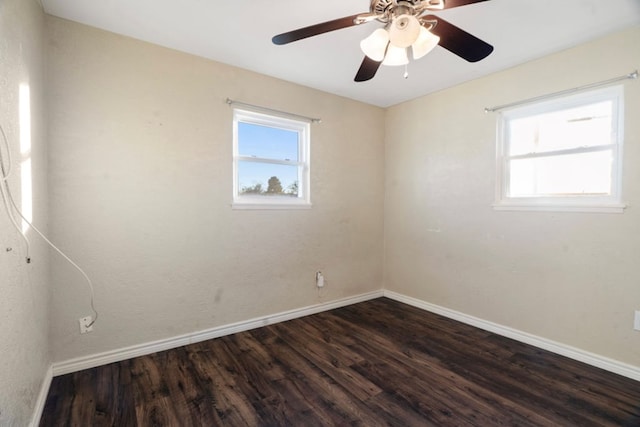 unfurnished room with dark hardwood / wood-style flooring and ceiling fan