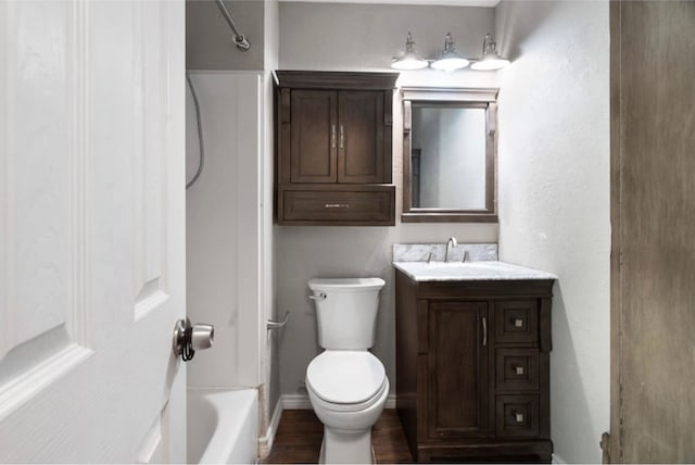 full bathroom with vanity, toilet, wood-type flooring, and washtub / shower combination