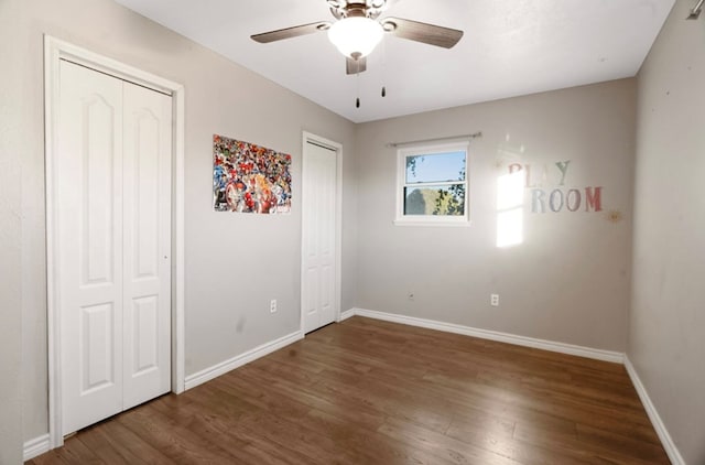 unfurnished bedroom with ceiling fan and hardwood / wood-style floors