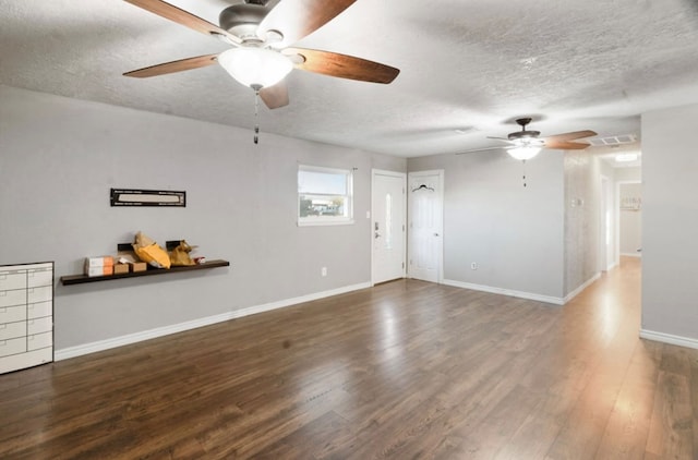 interior space with a textured ceiling and dark wood-type flooring