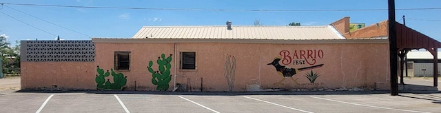 view of building exterior featuring uncovered parking