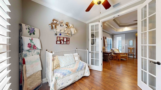 living area featuring crown molding, french doors, ceiling fan, and wood-type flooring