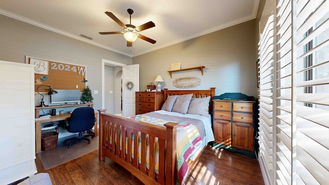 bedroom featuring dark hardwood / wood-style flooring, ceiling fan, and ornamental molding