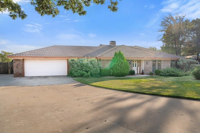 single story home featuring a garage and a front lawn