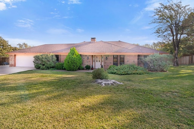 4 Glenwick Cv, Big Spring, TX 79720 - ranch-style home featuring fence, an attached garage, brick siding, a front yard, and concrete driveway
