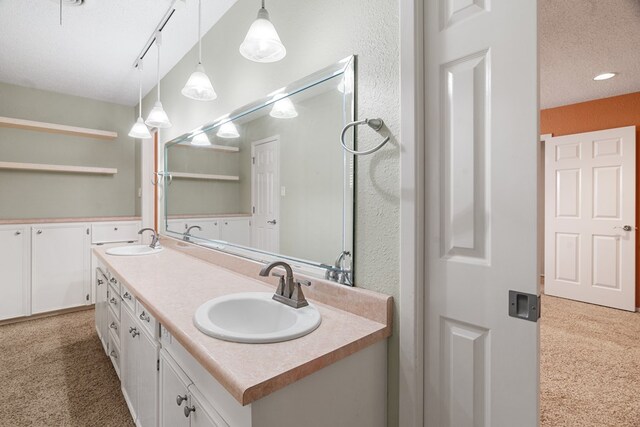 bathroom featuring vanity and a textured ceiling