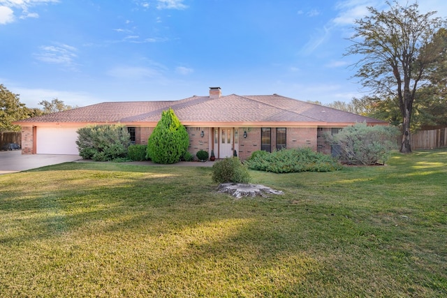 single story home featuring a front lawn and a garage