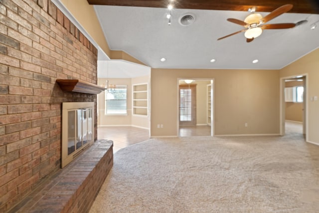 unfurnished living room with ceiling fan, a brick fireplace, carpet floors, vaulted ceiling, and a textured ceiling