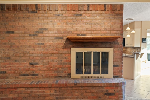 interior details with a textured ceiling and a fireplace