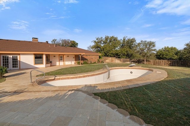 view of pool featuring a patio area and a yard