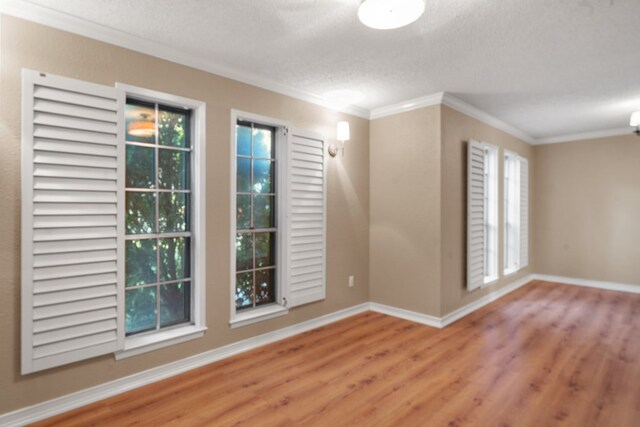 unfurnished room with ornamental molding, a textured ceiling, and hardwood / wood-style flooring