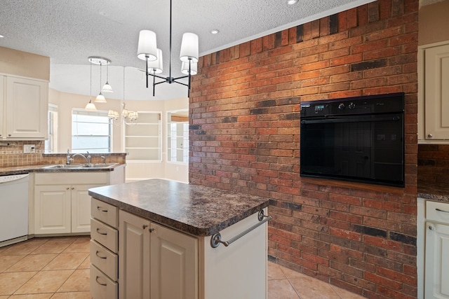 kitchen with dishwasher, a center island, hanging light fixtures, sink, and oven