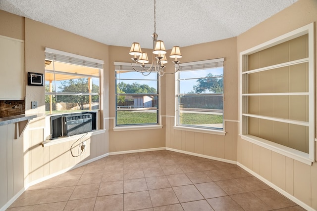 4 Glenwick Cv, Big Spring, TX 79720 - unfurnished dining area with a textured ceiling, an inviting chandelier, and a healthy amount of sunlight