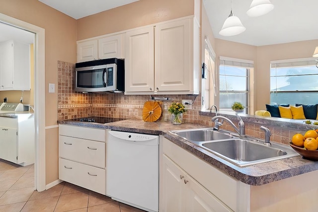 kitchen with white cabinets, sink, dishwasher, washer / clothes dryer, and hanging light fixtures