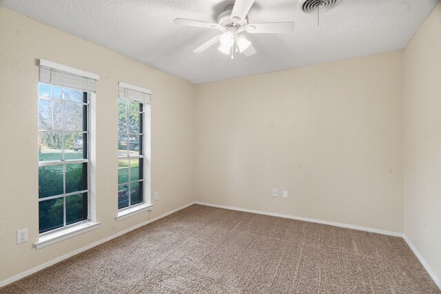 unfurnished room featuring carpet, ceiling fan, and a textured ceiling