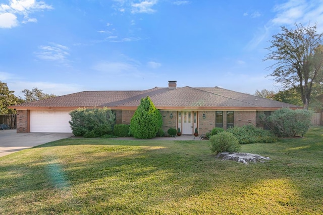 single story home with a front yard and a garage