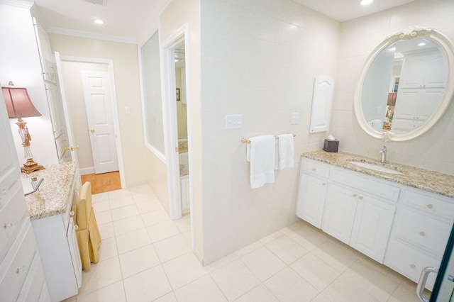 bathroom featuring tile patterned flooring, vanity, and ornamental molding