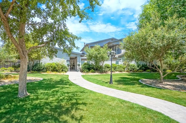 view of property's community with a lawn