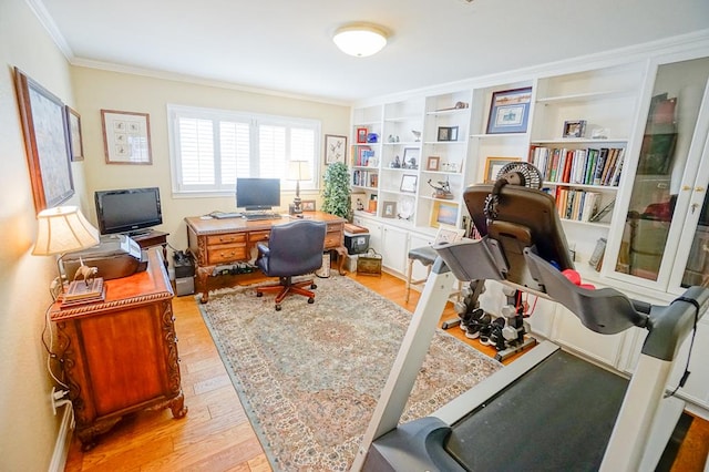 office space with light wood-type flooring and crown molding