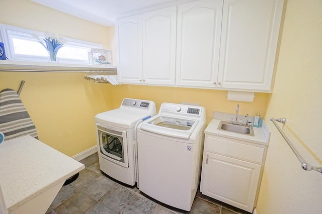 laundry room with cabinets, sink, and washing machine and dryer