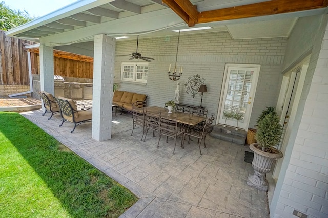 view of patio / terrace featuring ceiling fan, an outdoor kitchen, and an outdoor hangout area