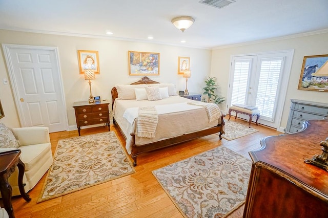 bedroom with light hardwood / wood-style floors, access to exterior, and ornamental molding