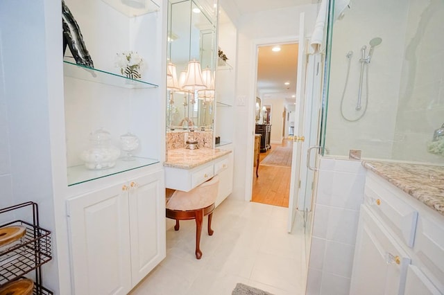 bathroom featuring tile patterned floors, vanity, and an enclosed shower