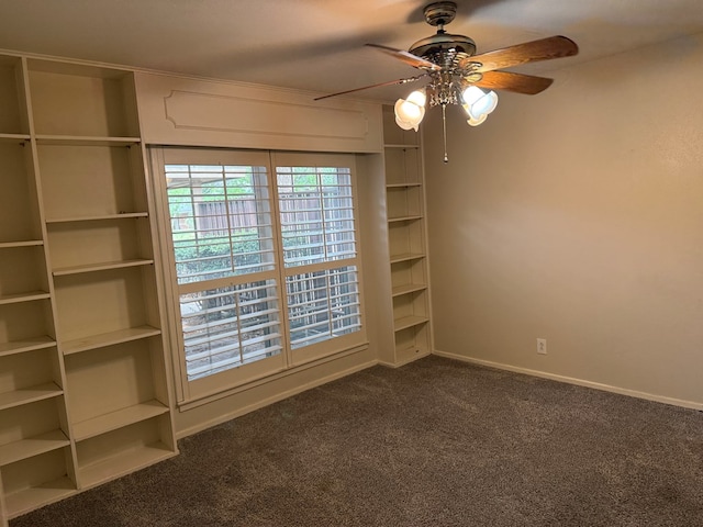 unfurnished room featuring ceiling fan, dark carpet, and baseboards